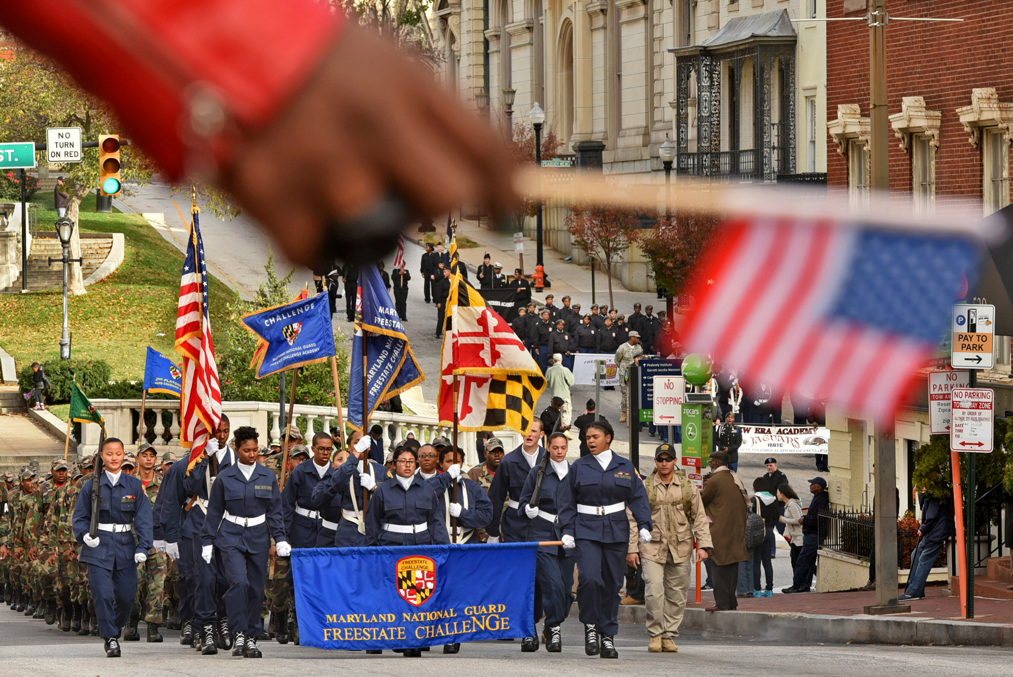 Young people in the Maryland National Guard Freestate ChalleNGe march down North Charles Street in the Veteran's Day Parade, from Centre Street to War Memorial Plaza.
